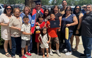 Richard Valdez graduated in 1983 and returned 40 years later to walk in Fresno State's commencement ceremony. Here, he is surrounded by about a dozen family members.